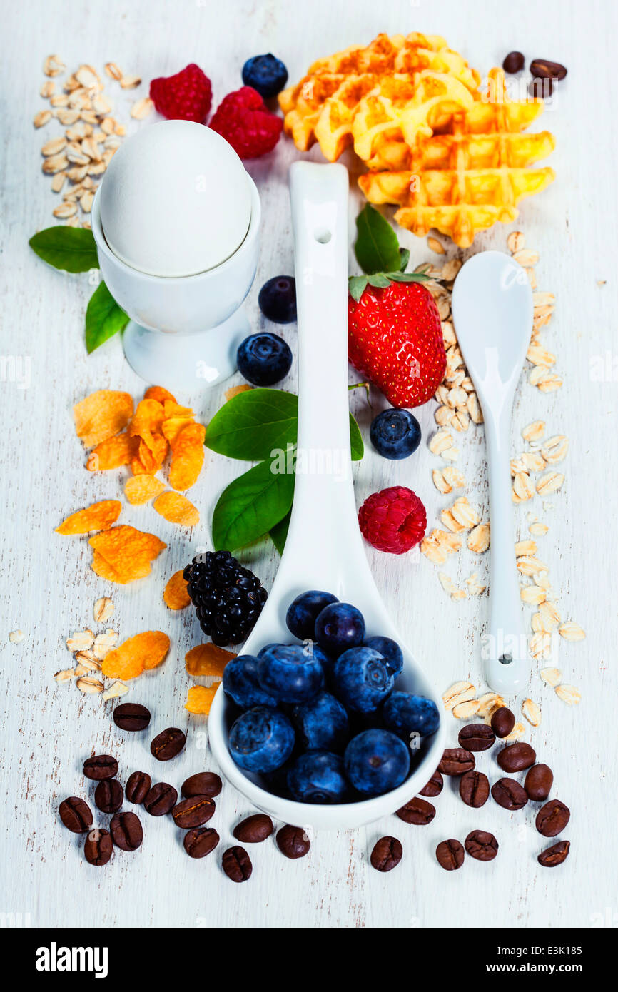 Healthy Breakfast.Oat flake, berries and coffee on wooden table. Health and diet concept Stock Photo