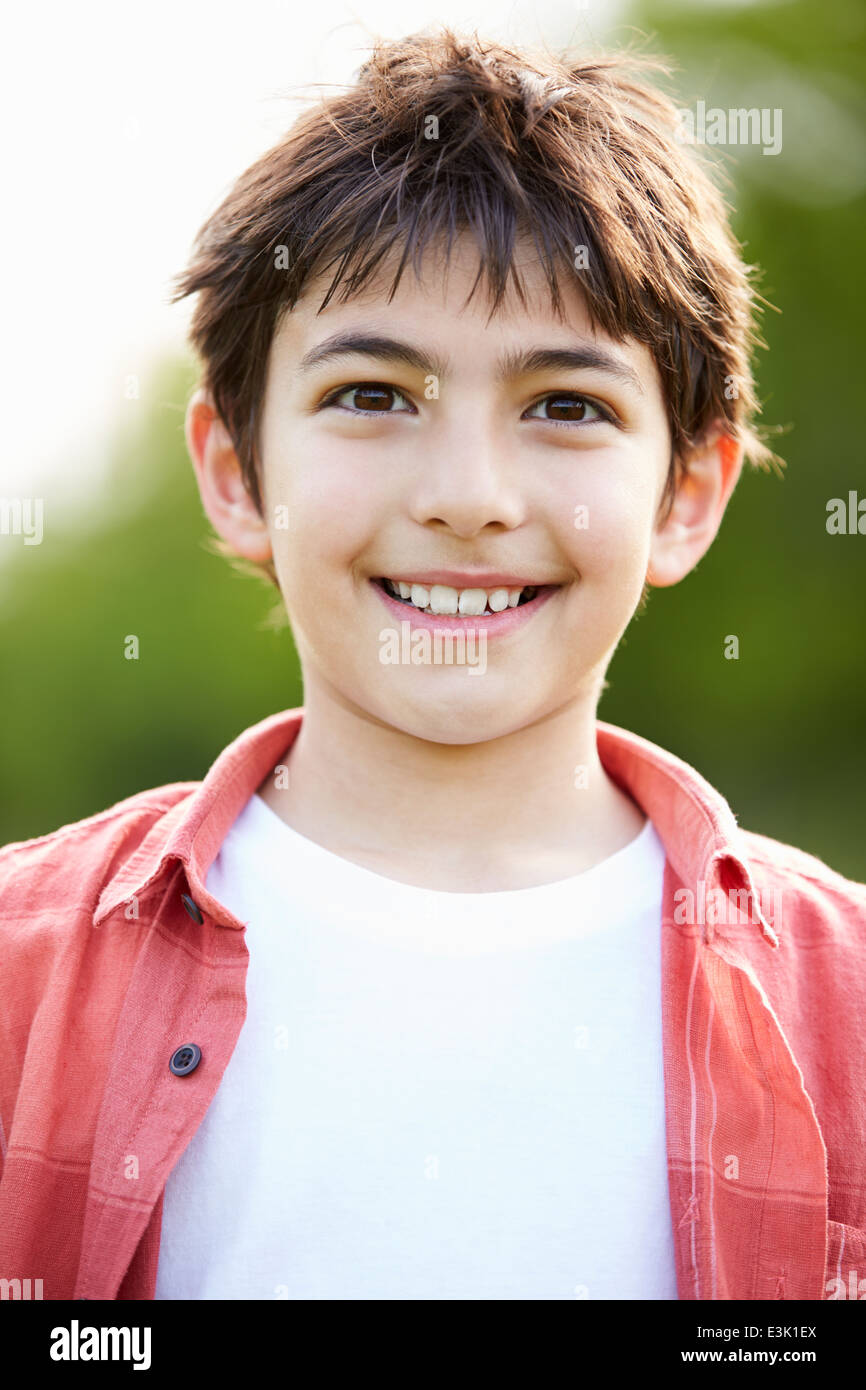 Portrait Of Smiling Hispanic Boy In Countryside Stock Photo