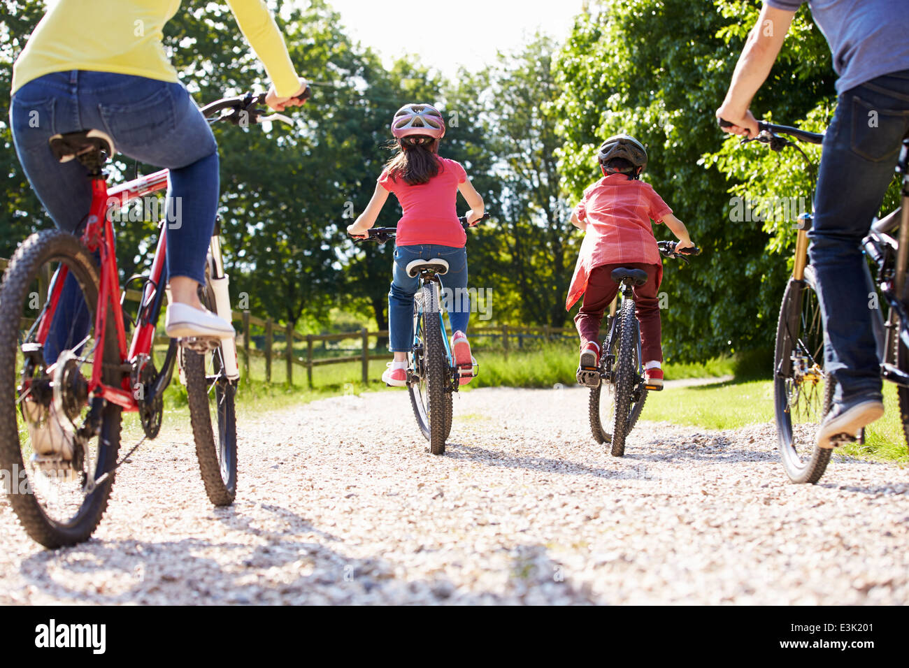 Rear View Of Hispanic Family On Cycle Ride In Countryside Stock Photo