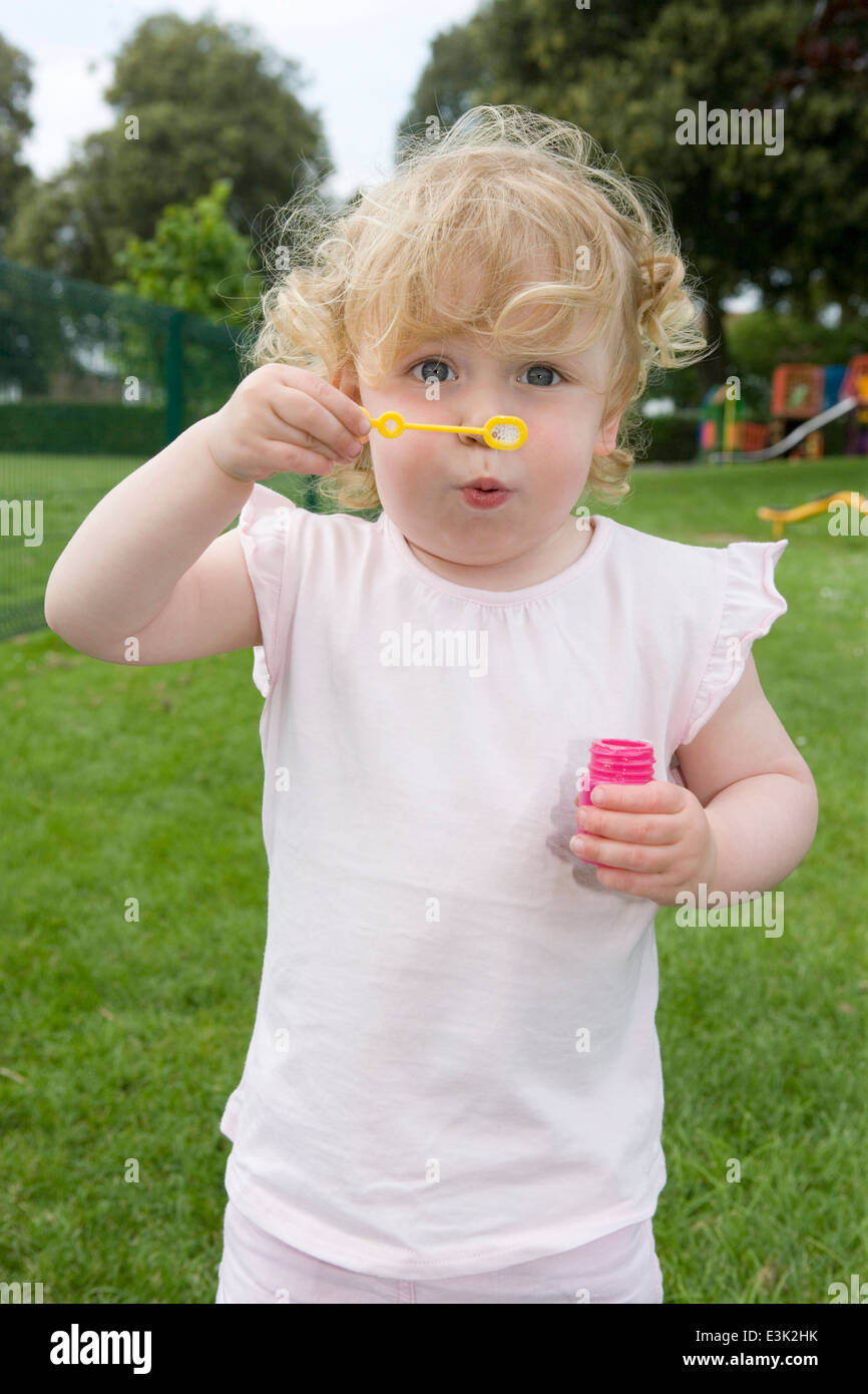 Girl blowing bubbles camera hi-res stock photography and images - Alamy
