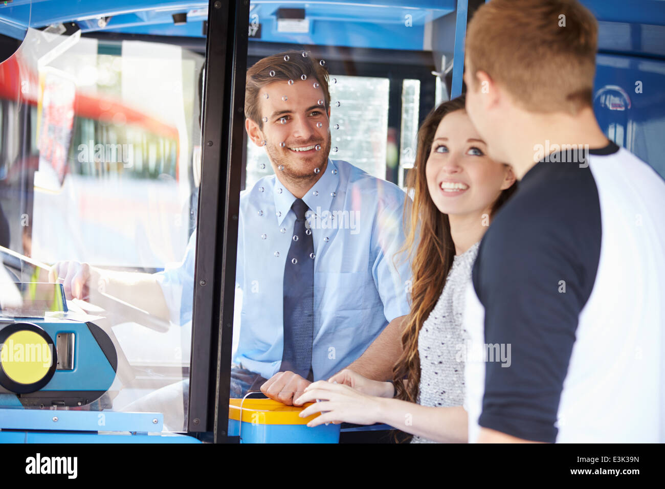 Young Couple Boarding Bus And Buying Ticket Stock Photo