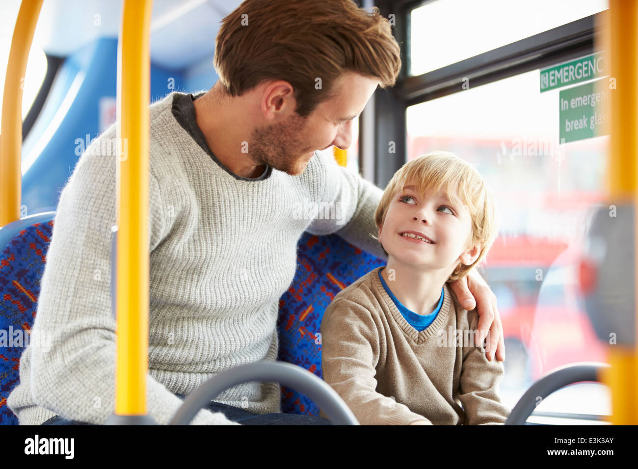 Father And Son Enjoying Bus Journey Together Stock Photo