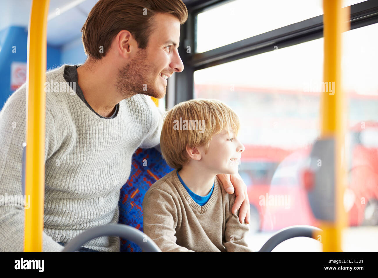 Father And Son Enjoying Bus Journey Together Stock Photo