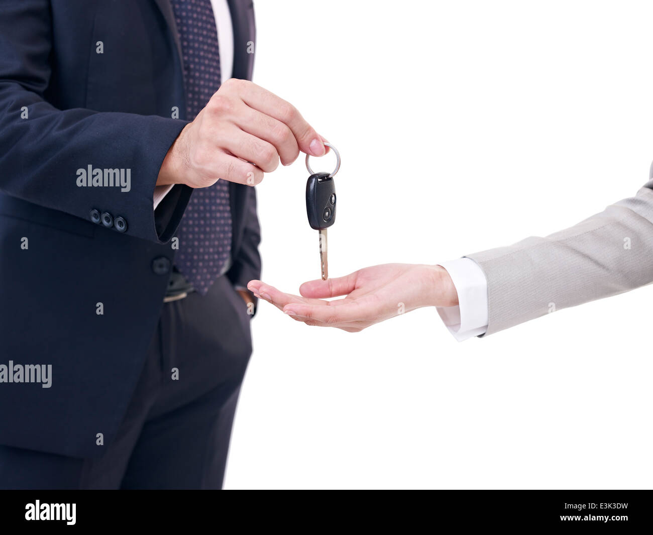 man handing over car key to woman Stock Photo