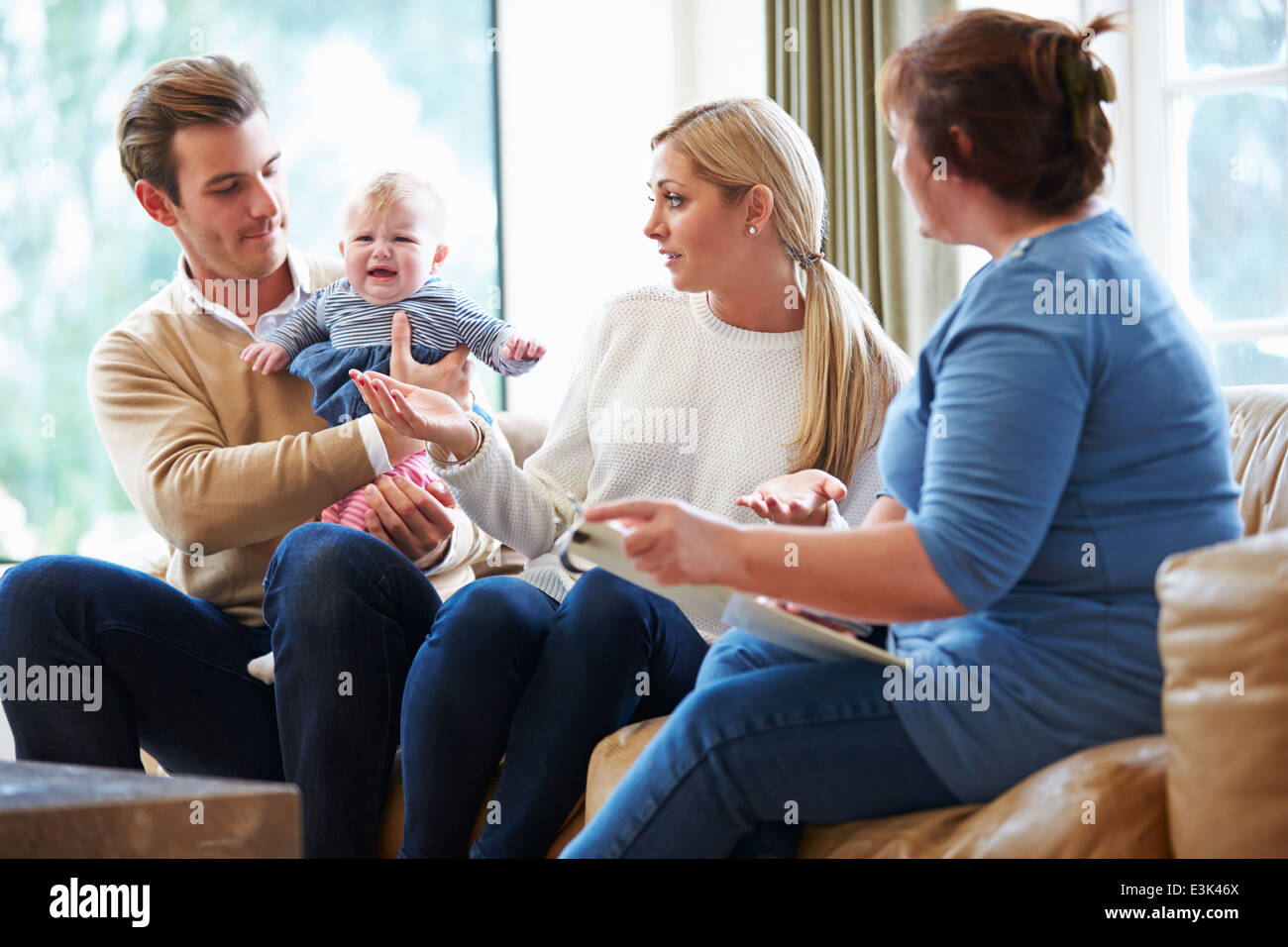 Social Worker Visiting Family With Young Baby Stock Photo