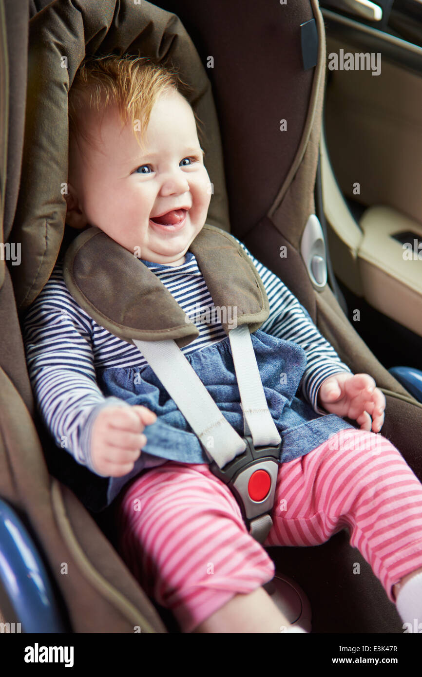 Baby Sitting Happily In Car Seat Stock Photo