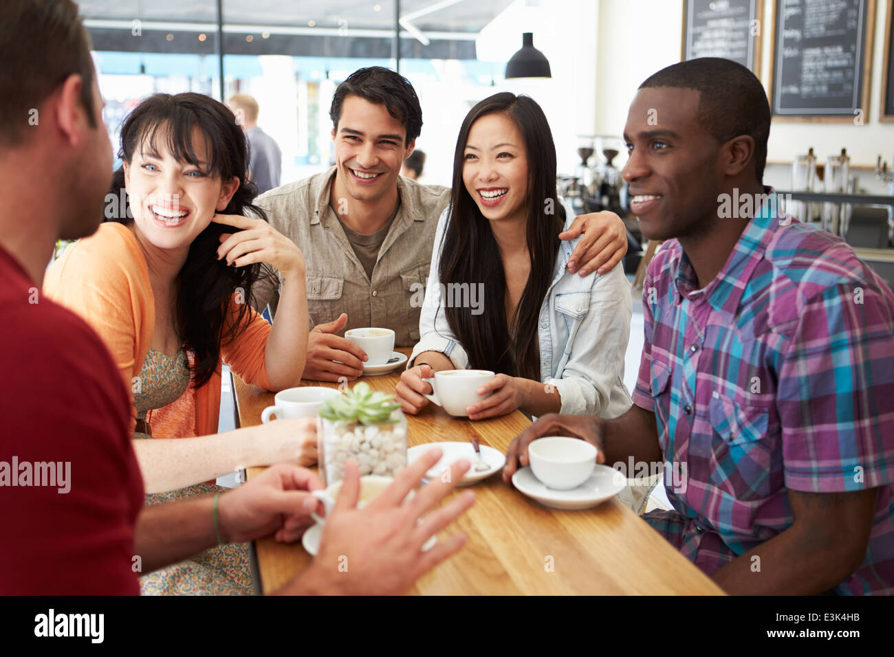 Group Of Friends Meeting In Coffee Shop Stock Photo