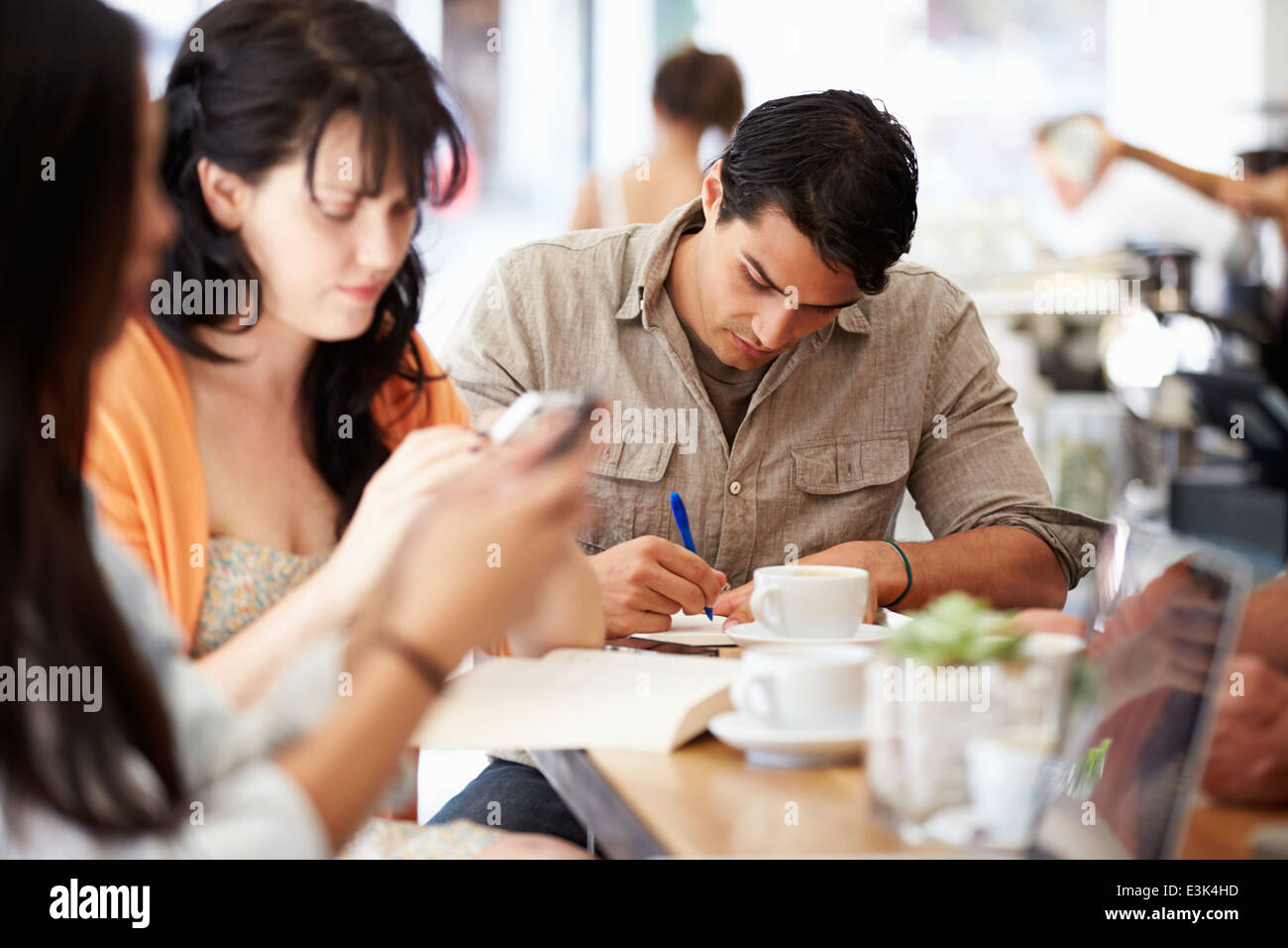 Customers In Busy Coffee Shop Stock Photo