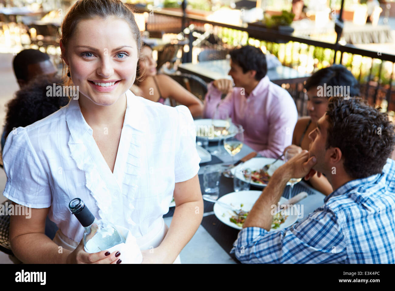 Waitress Serving Tables At Outdoor Restaurant Stock Photo