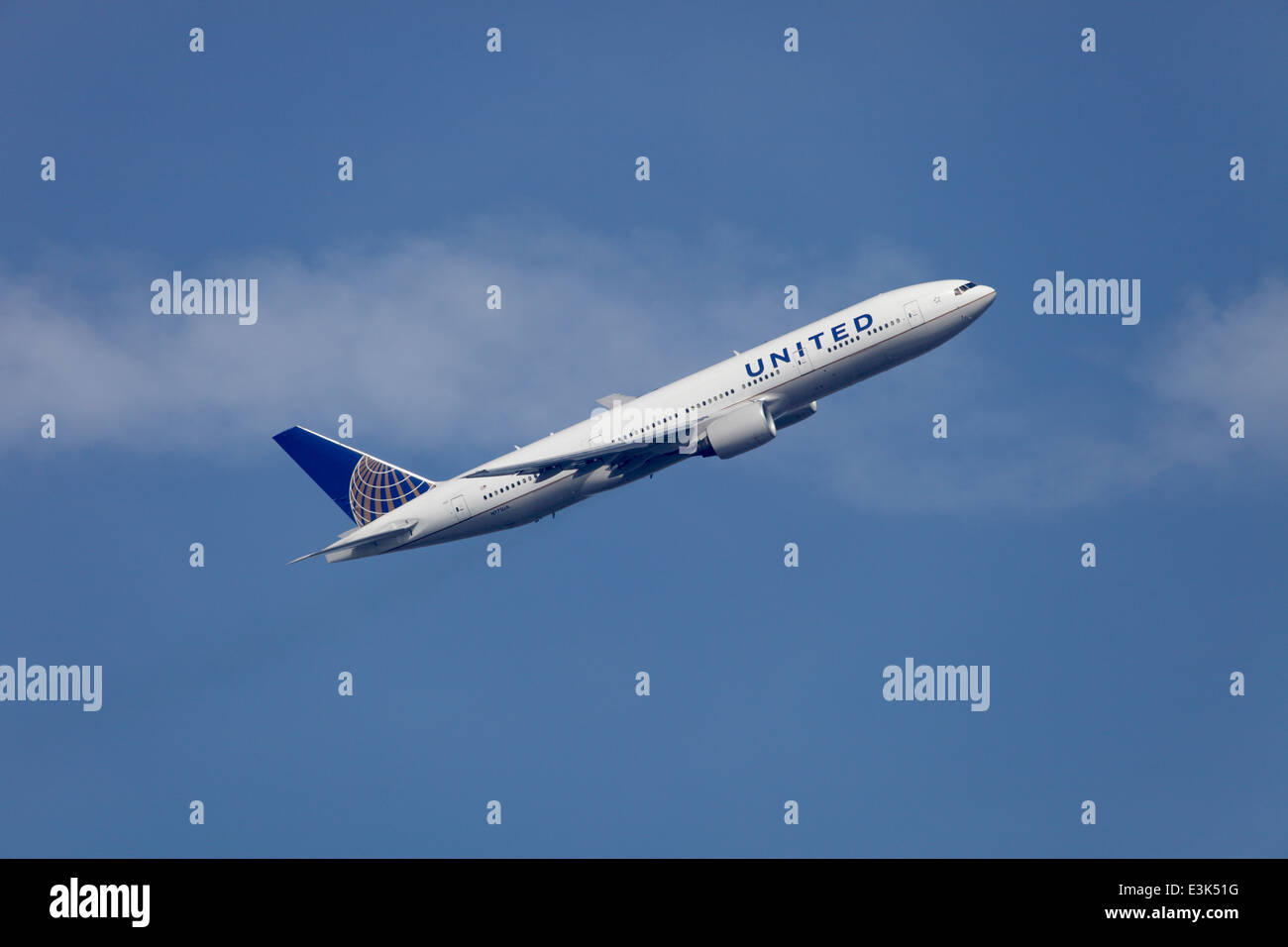 United Airlines Boeing 777-222 N775UA climbing away from Heathrow airport Stock Photo