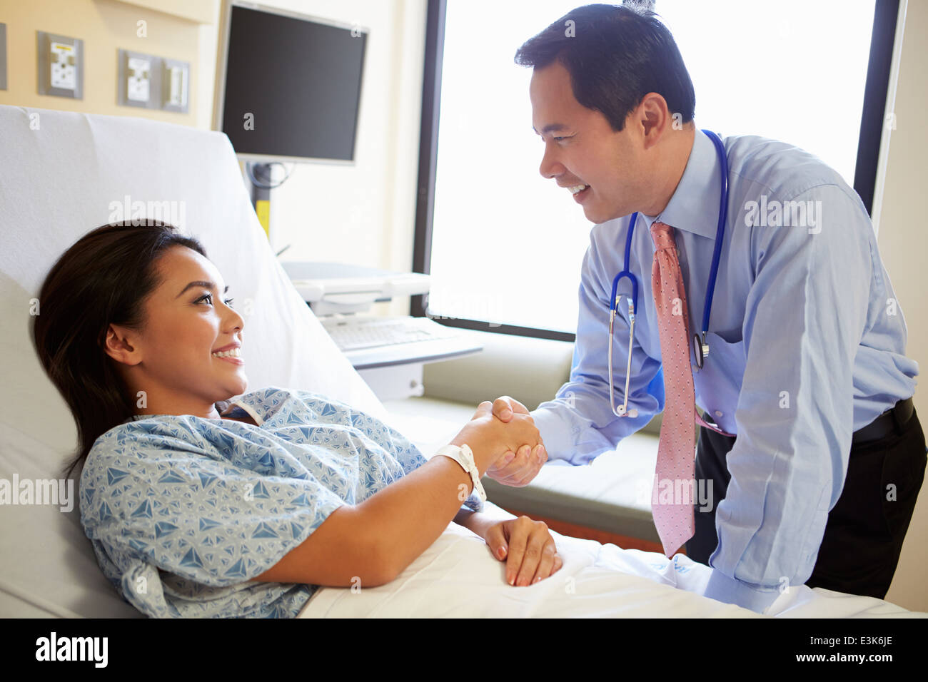 Doctor Talking To Female Patient On Ward Stock Photo