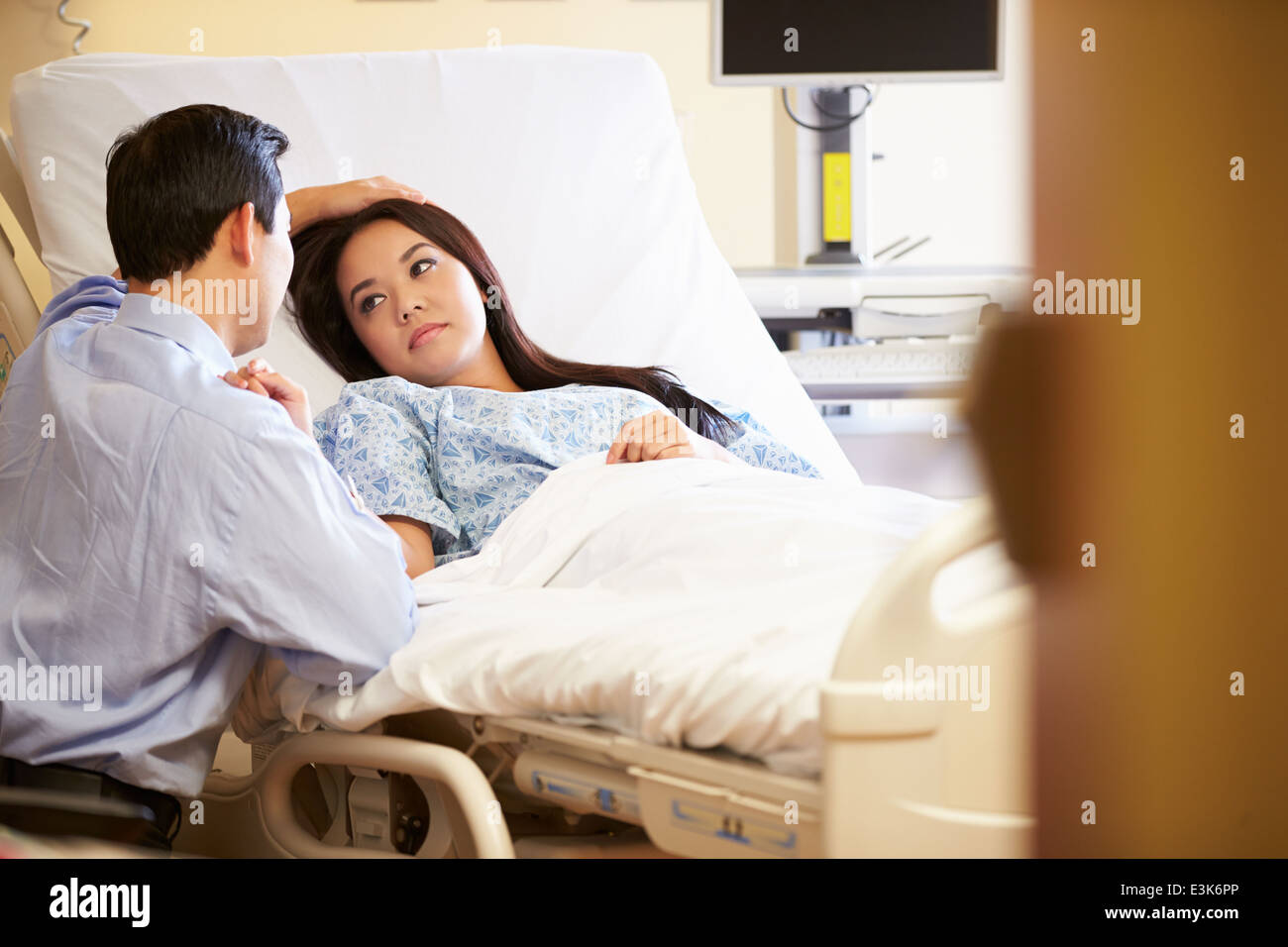 Husband Visiting Wife In Hospital Stock Photo