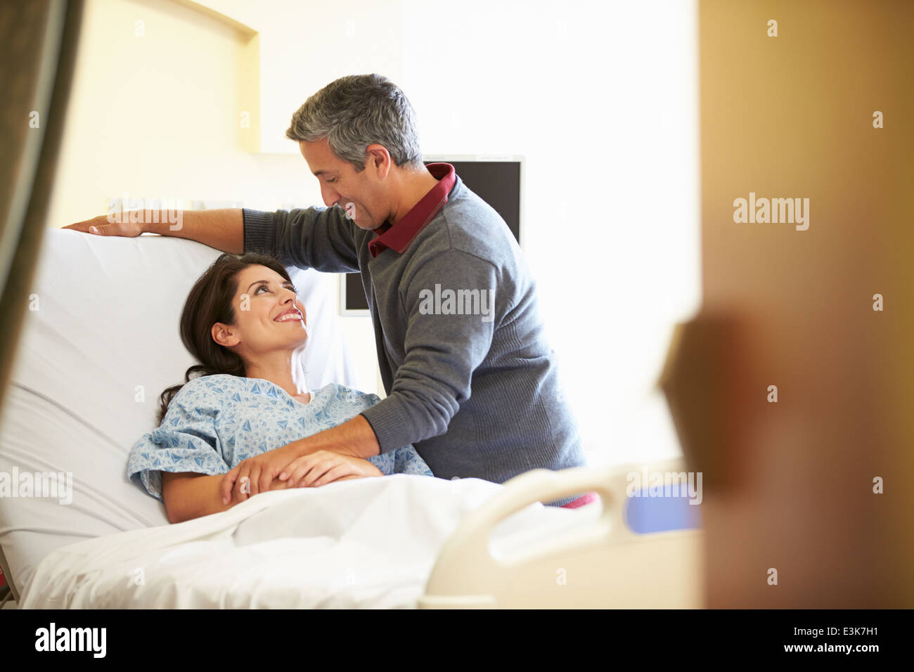Husband Visiting Wife In Hospital Stock Photo