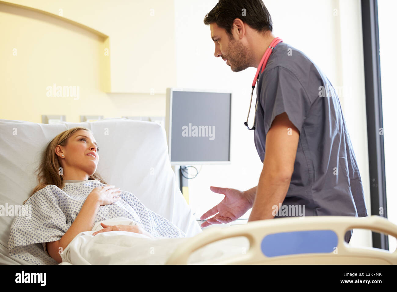 Male Nurse Talking With Female Patient In Hospital Room Stock Photo - Alamy
