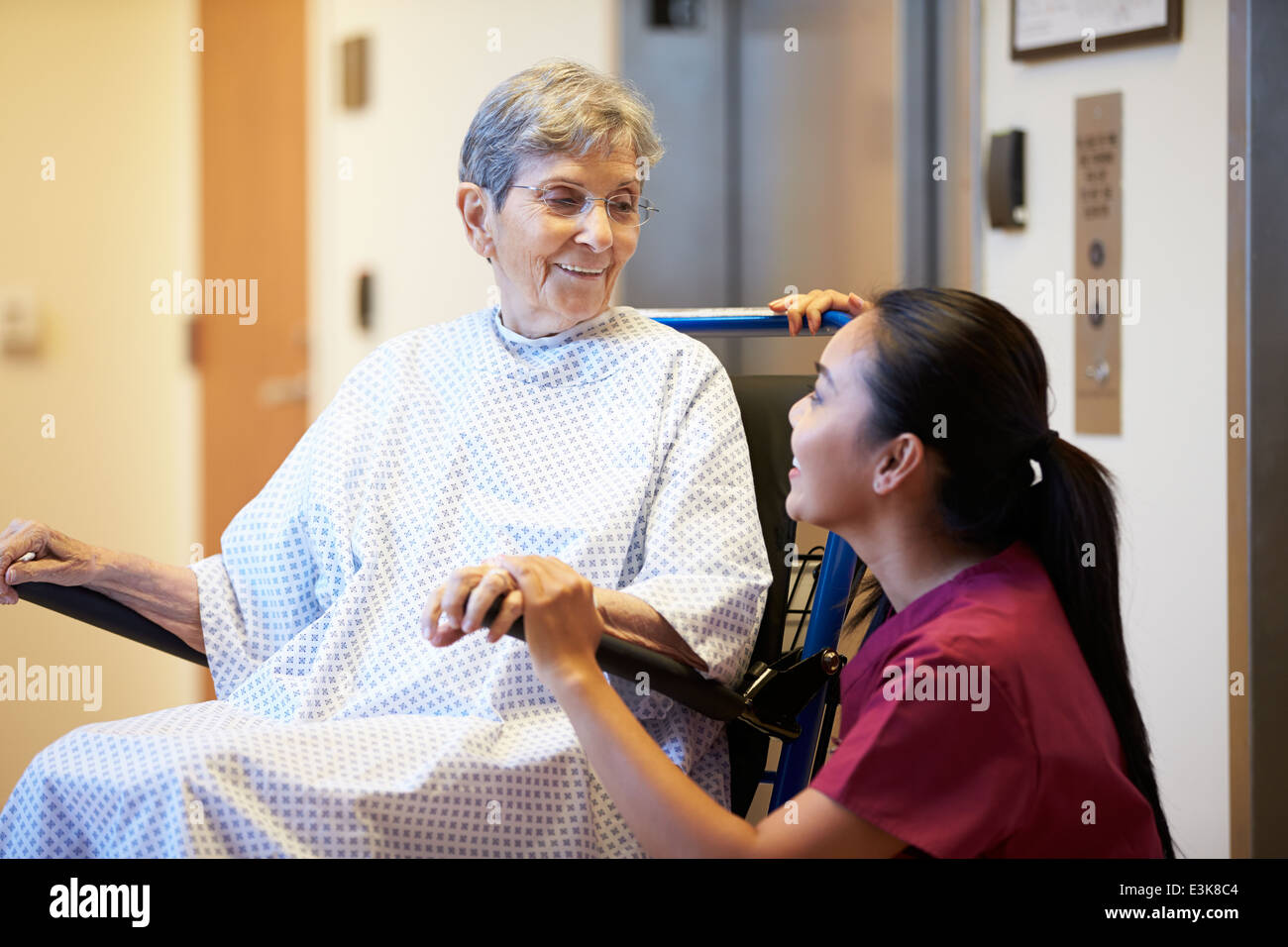 Senior Female Patient Being Pushed In Wheelchair By Nurse Stock Photo ...