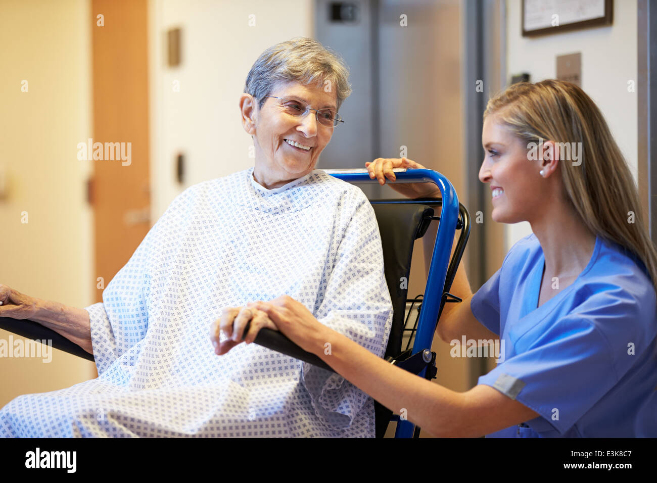 Senior Female Patient Being Pushed In Wheelchair By Nurse Stock Photo ...