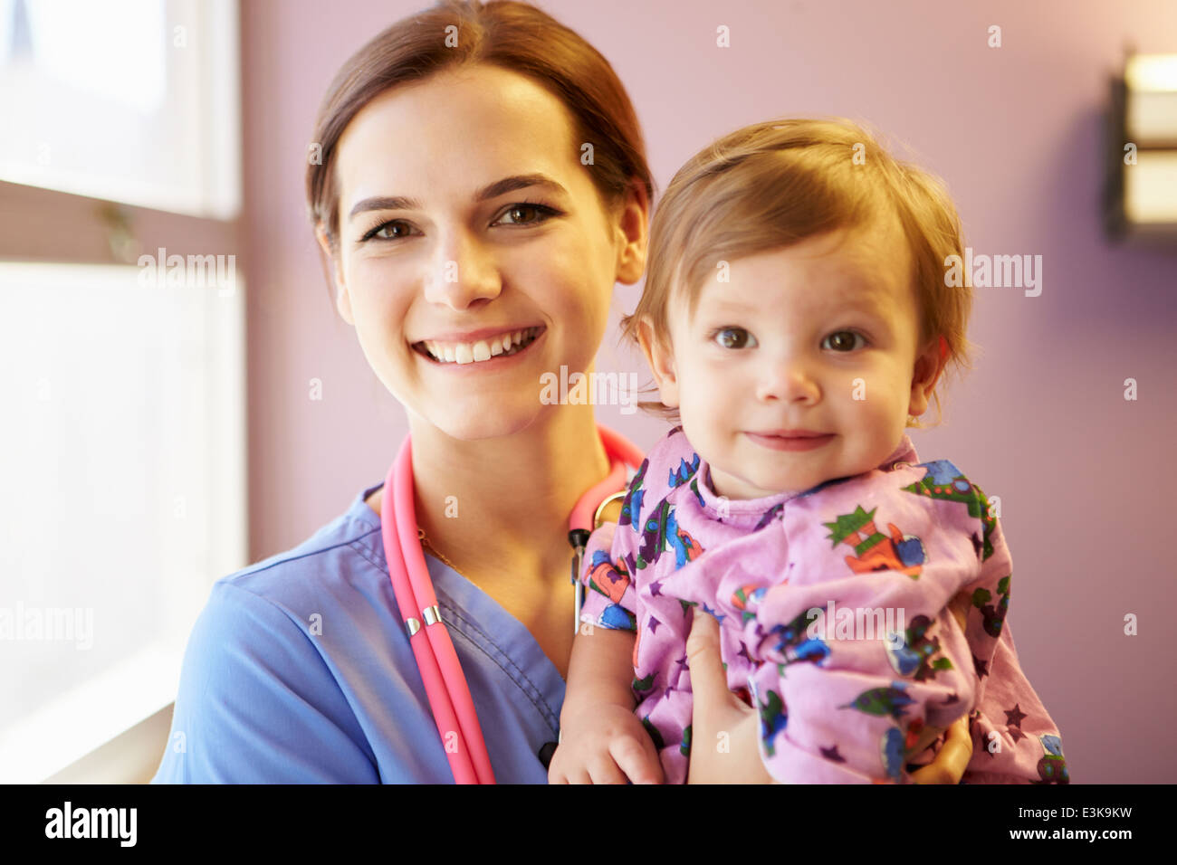 Young Girl Being Held By Female Pediatric Nurse Stock Photo