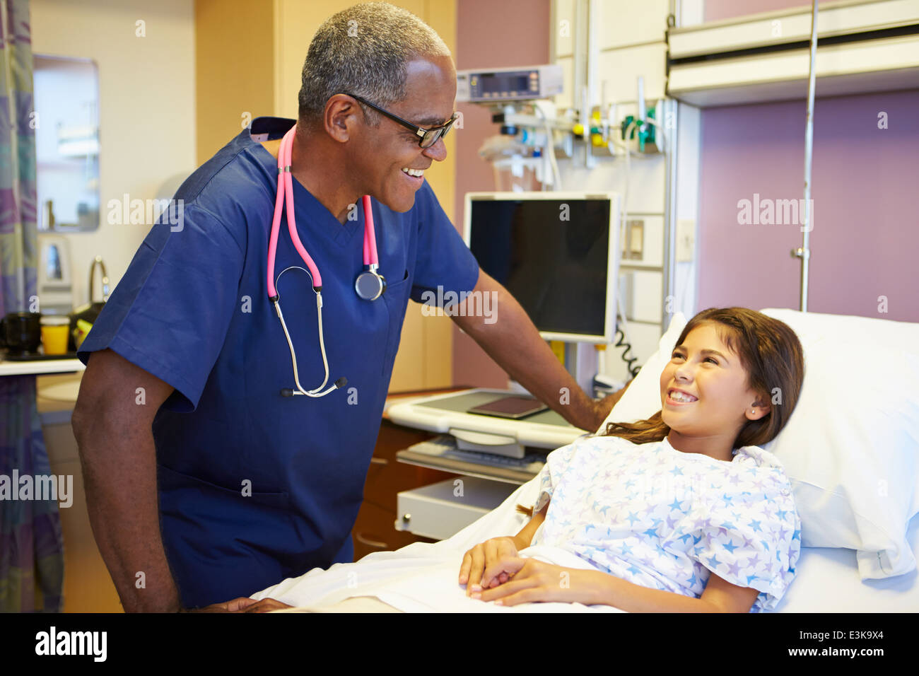 Young Girl Talking To Male Nurse In Hospital Room Stock Photo - Alamy