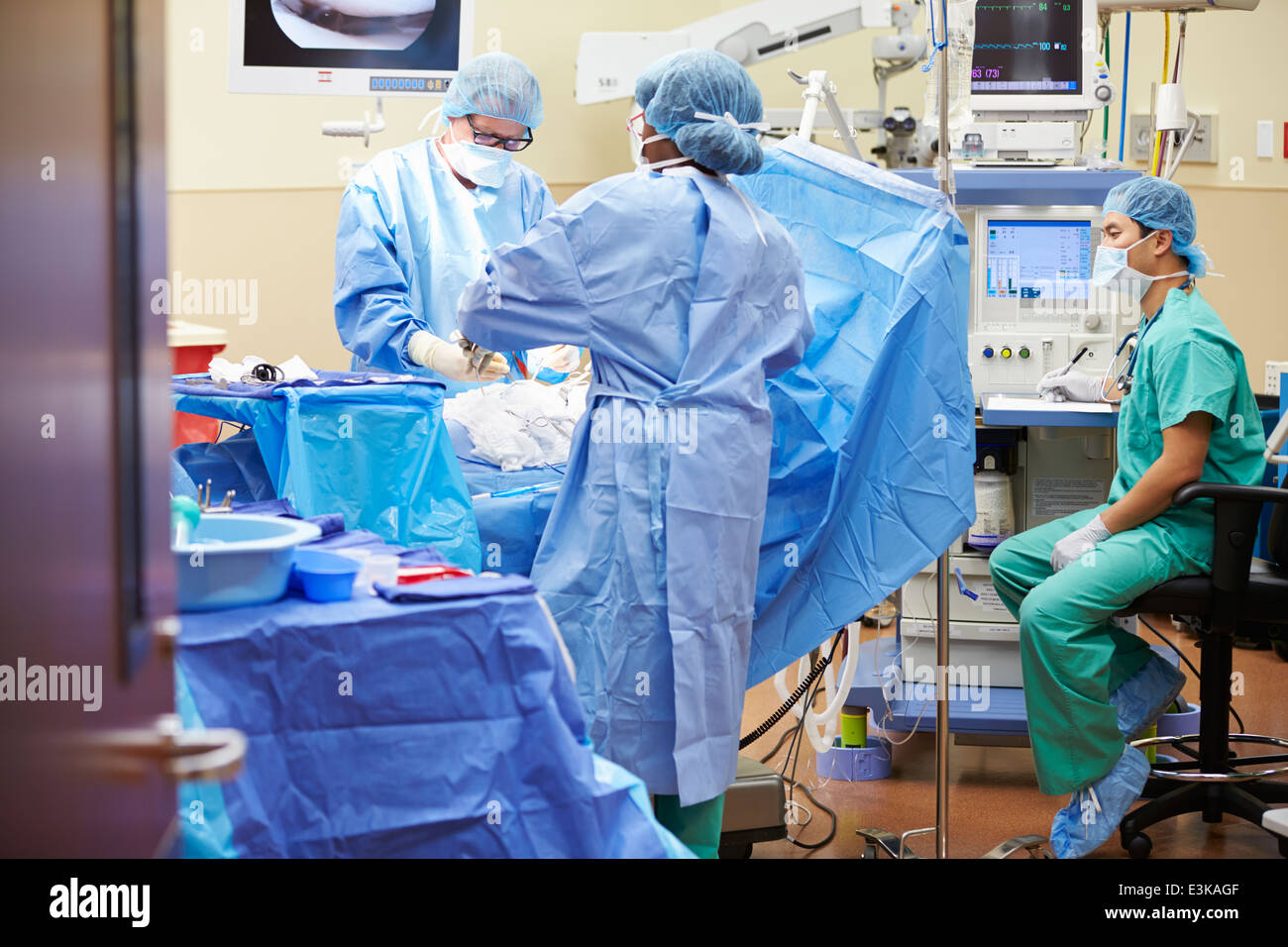 Surgical Team Working In Operating Theatre Stock Photo