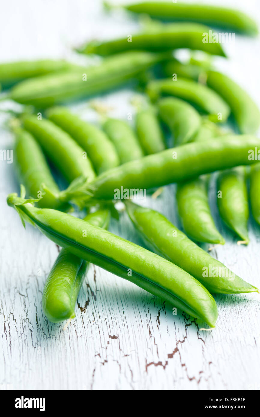 green pea pods on old cracked background Stock Photo - Alamy
