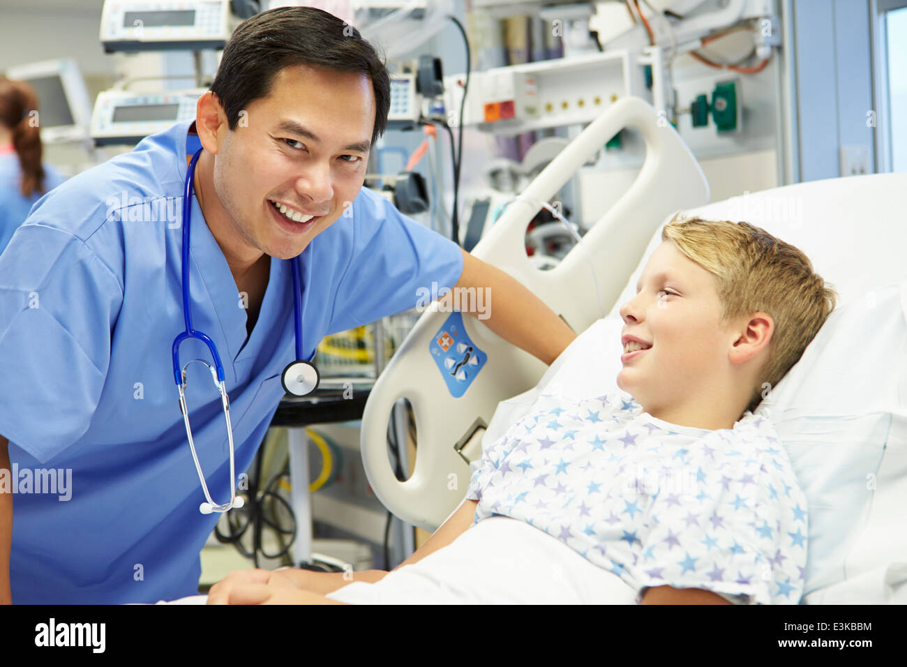 Boy Talking To Male Nurse In Emergency Room Stock Photo