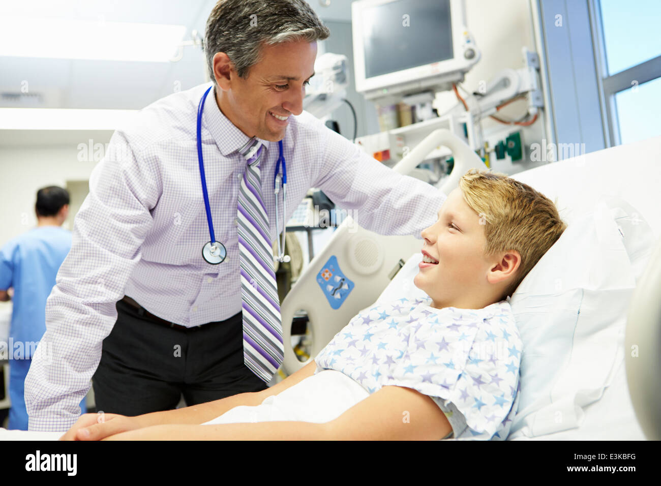 Boy Talking To Male Consultant In Emergency Room Stock Photo