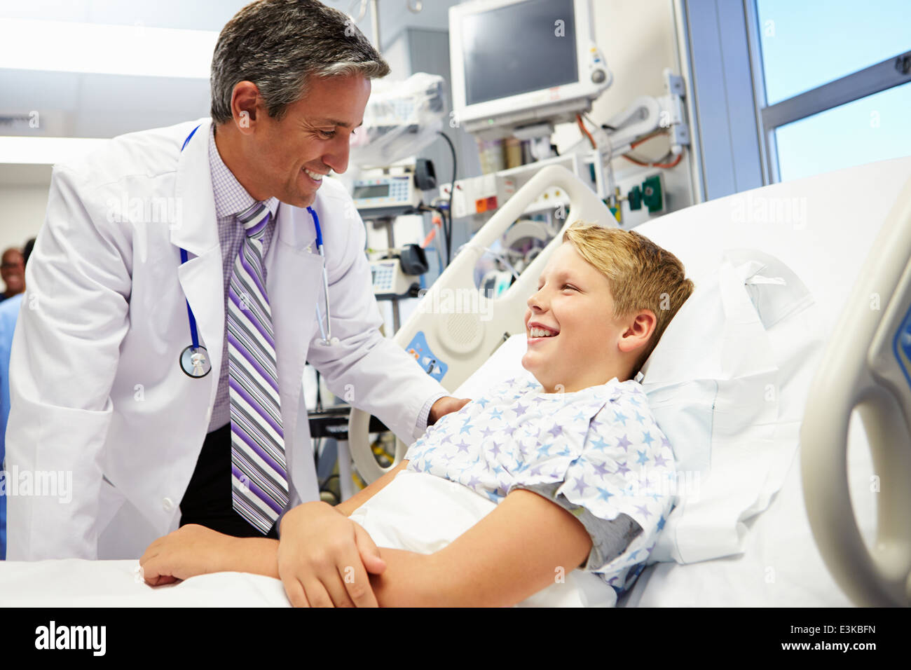 Boy Talking To Male Doctor In Emergency Room Stock Photo