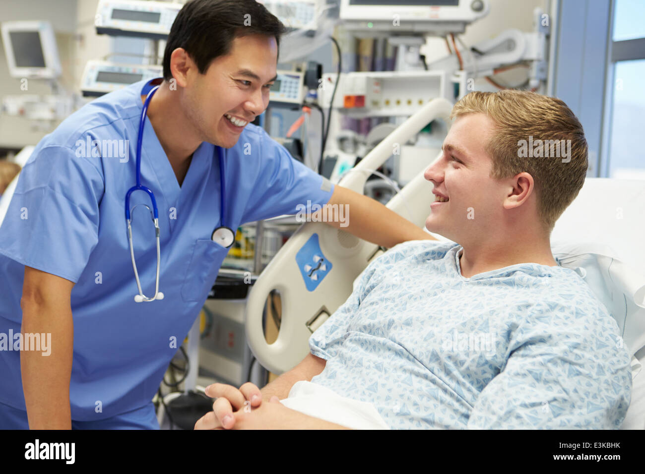 Young Male Patient Talking To Male Nurse In Emergency Room Stock Photo