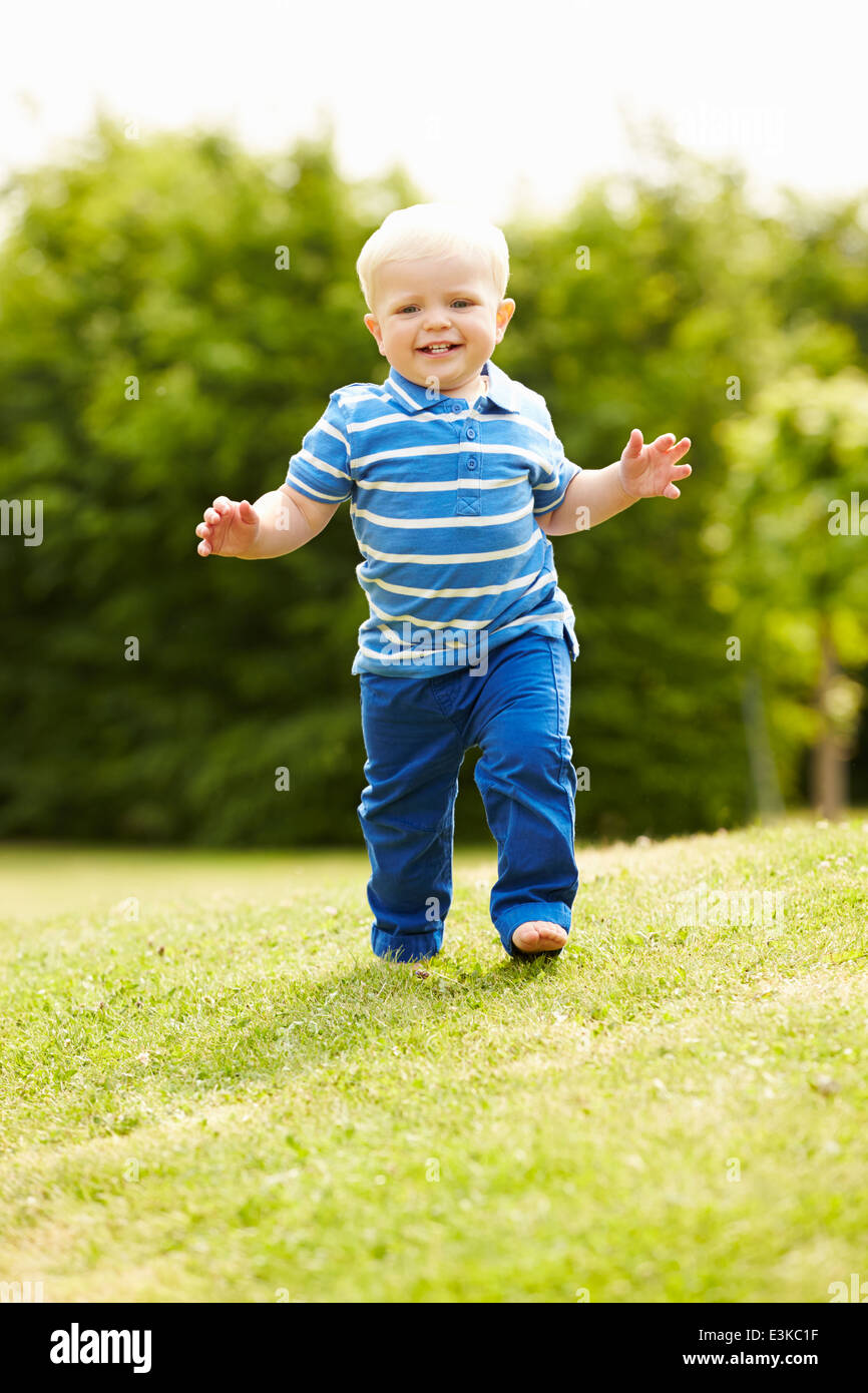 Young Boy Playing In Summer Garden Stock Photo