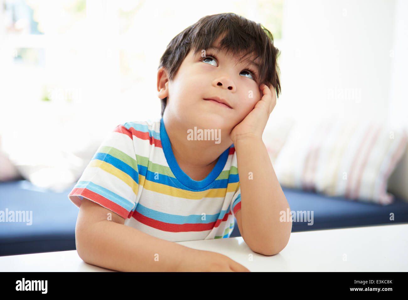 Asian Boy With Head In Hands Thinking Stock Photo