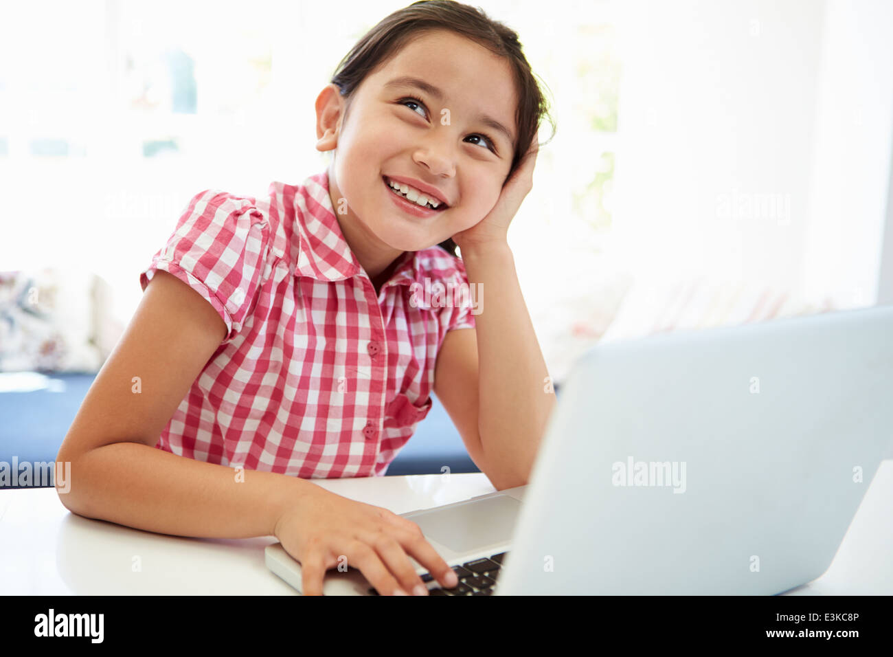 Asian Child Using Laptop At Home Stock Photo