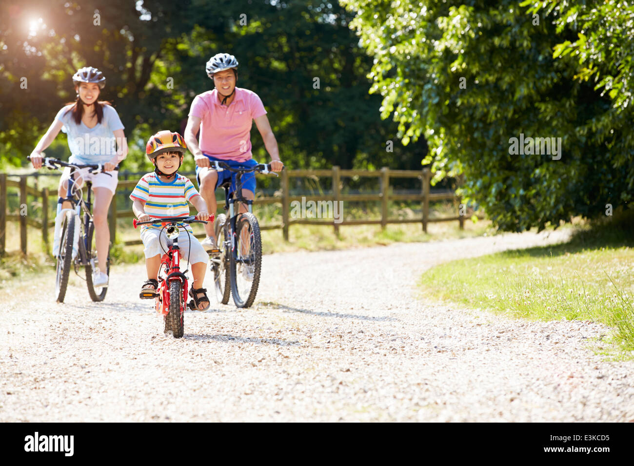 Asian Family On Cycle Ride In Countryside Stock Photo