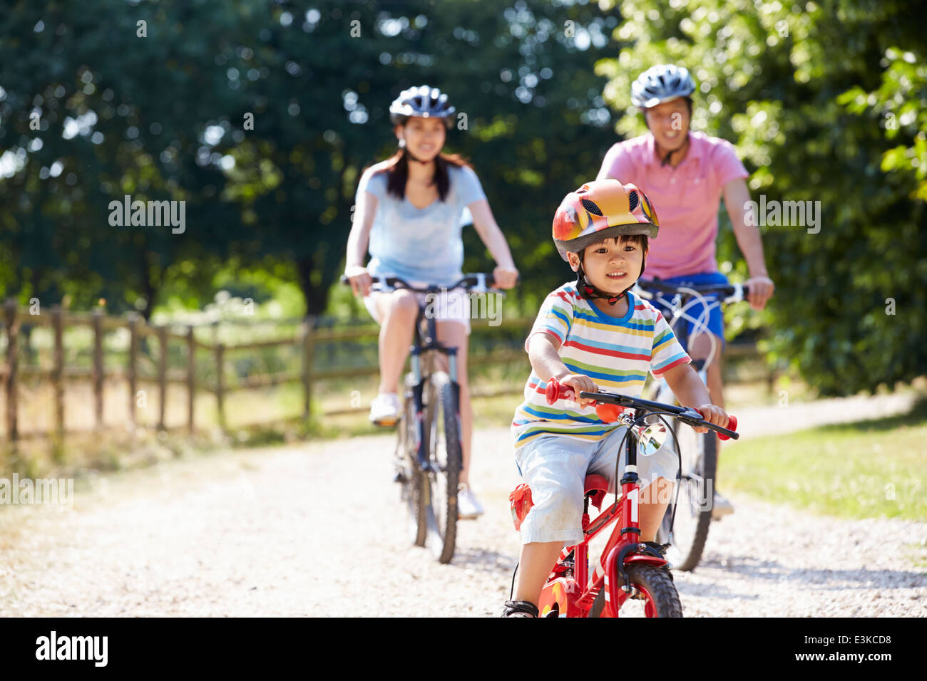 Asian Family On Cycle Ride In Countryside Stock Photo
