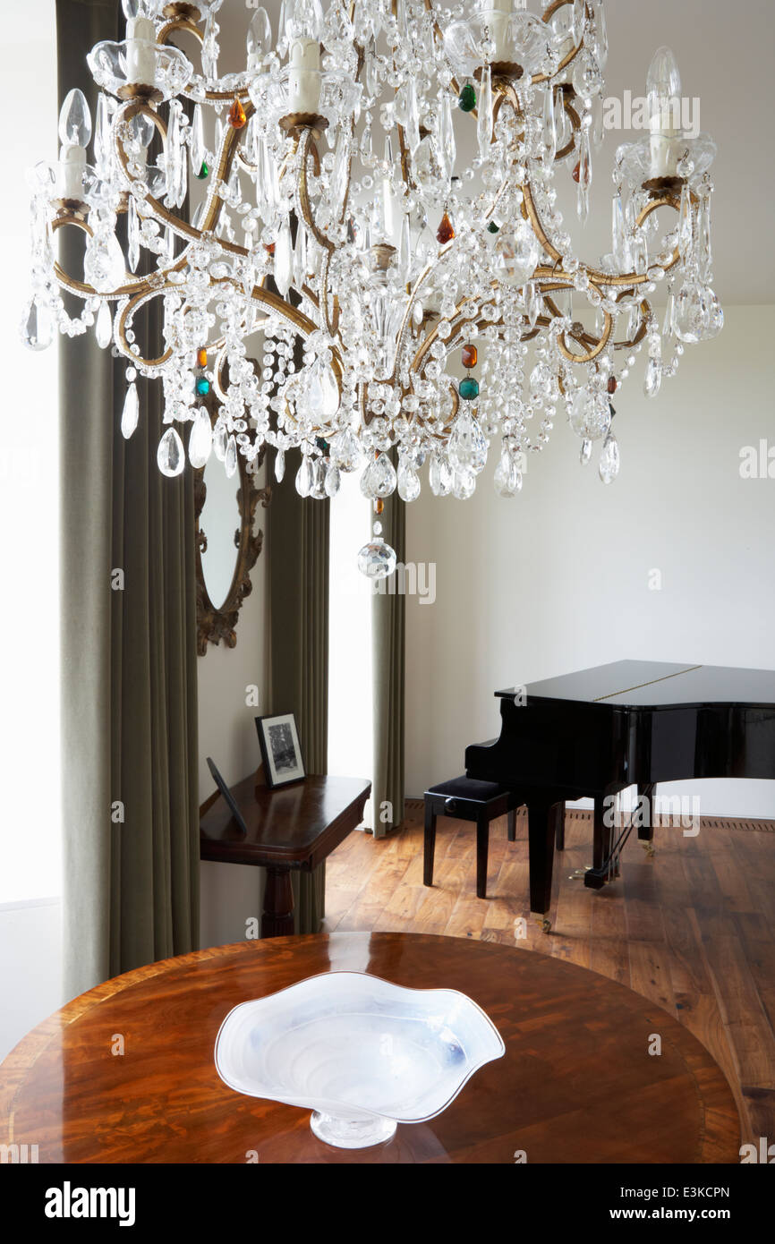Room In Modern House With Chandelier And Grand Piano Stock Photo