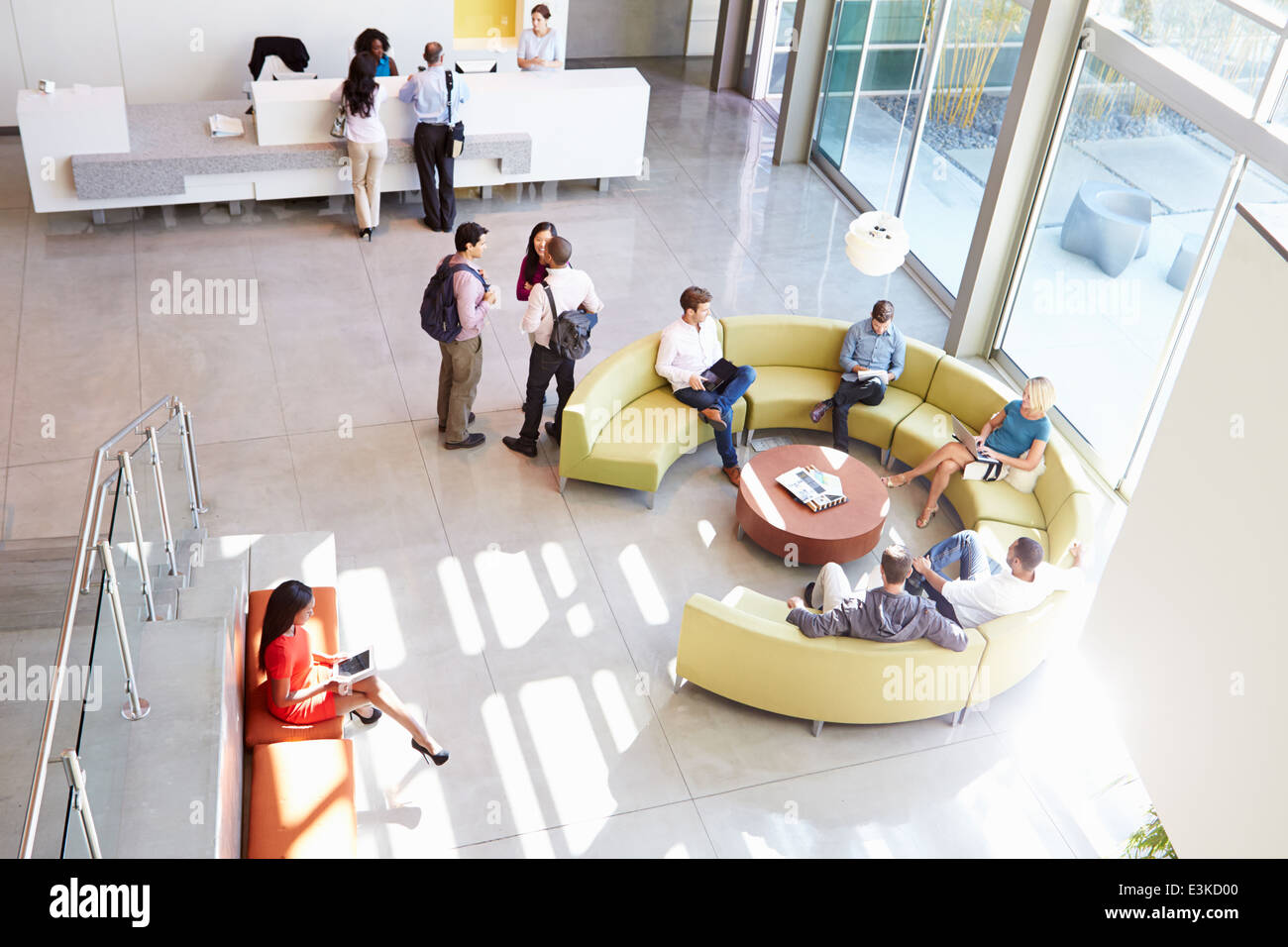 Reception Area Of Modern Office Building With People Stock Photo