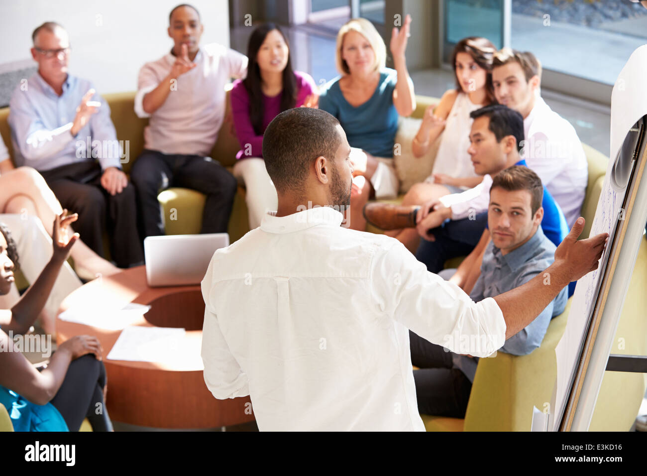 Businessman Making Presentation To Office Colleagues Stock Photo