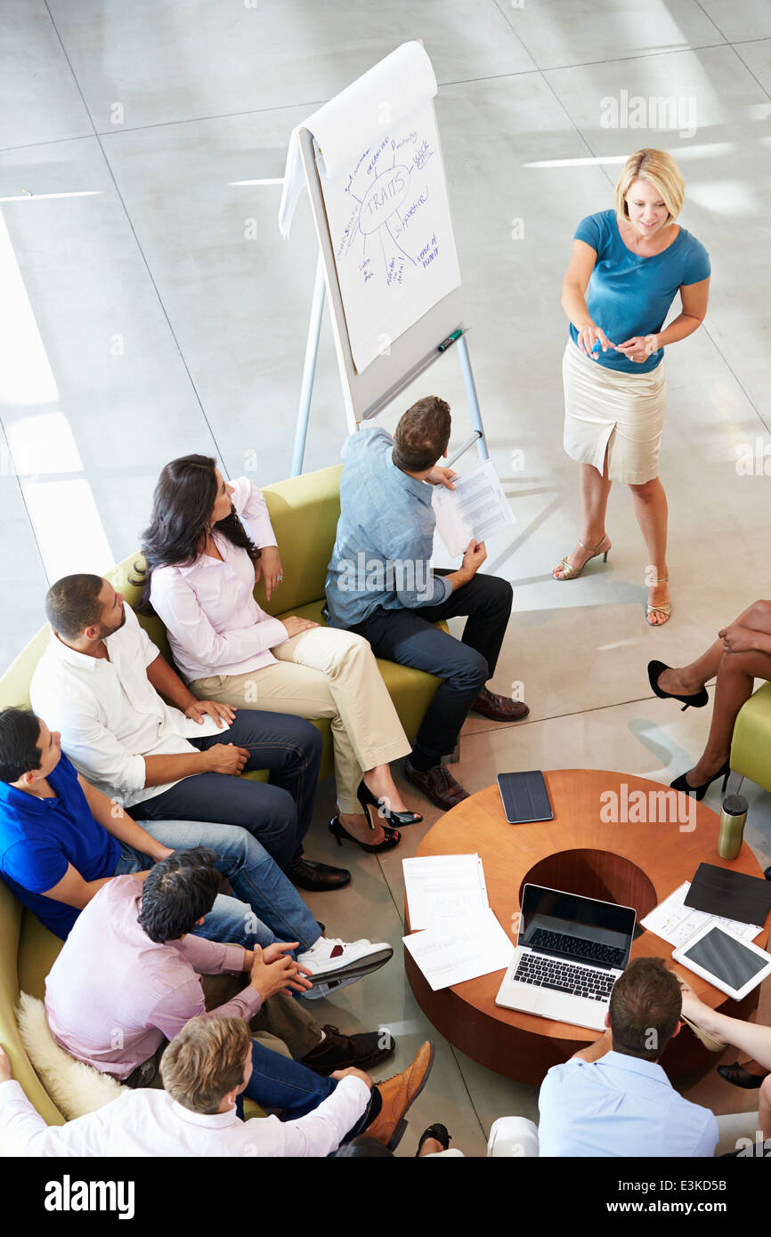 Businesswoman Making Presentation To Office Colleagues Stock Photo