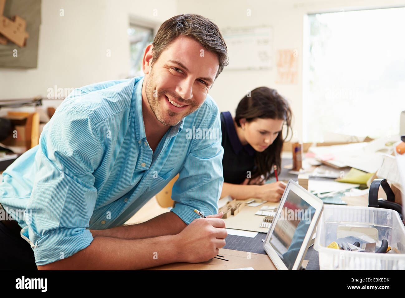 Two Architects Making Models In Office Using Digital Tablet Stock Photo