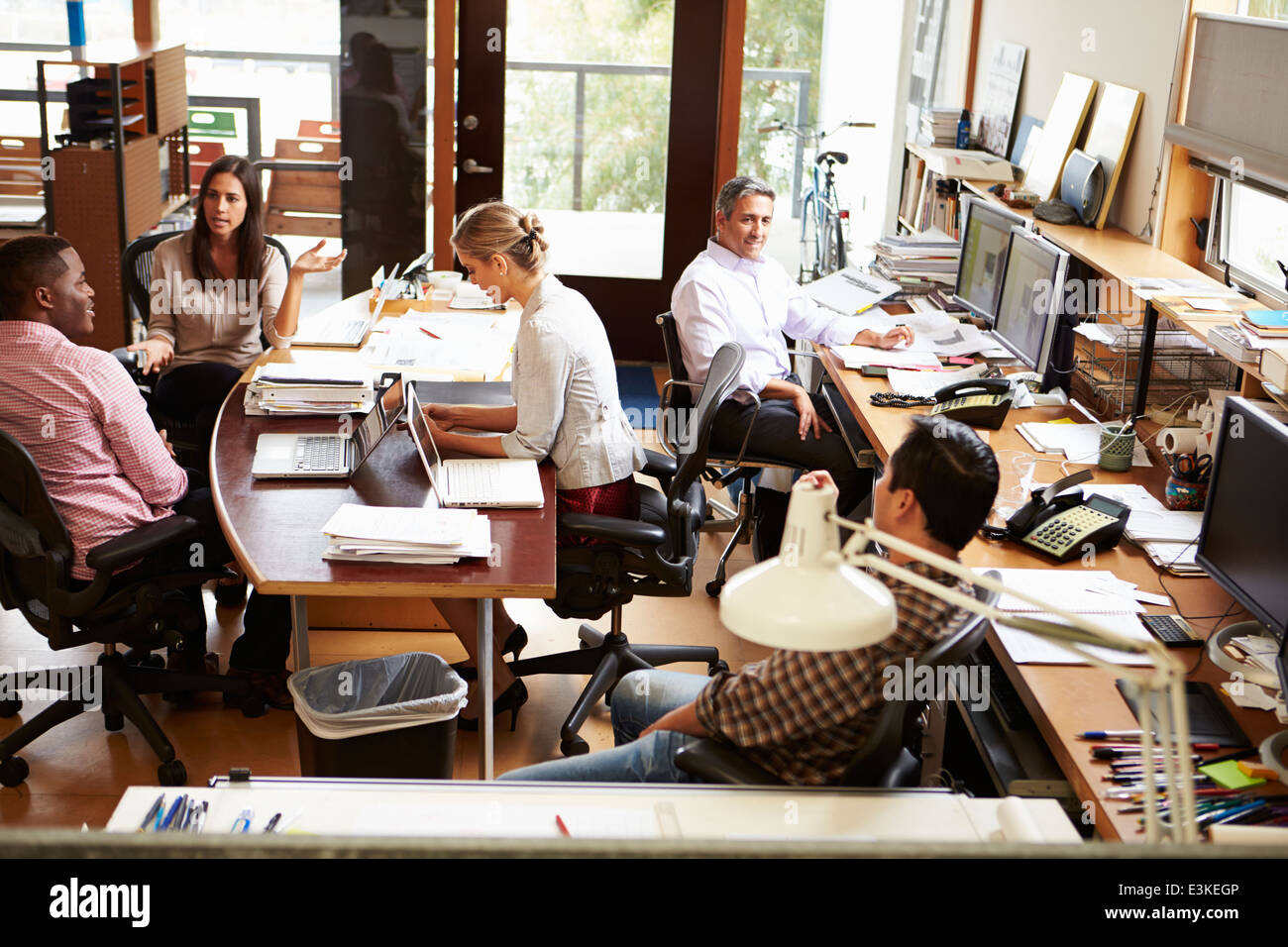 Interior Of Busy Architect's Office With Staff Working Stock Photo