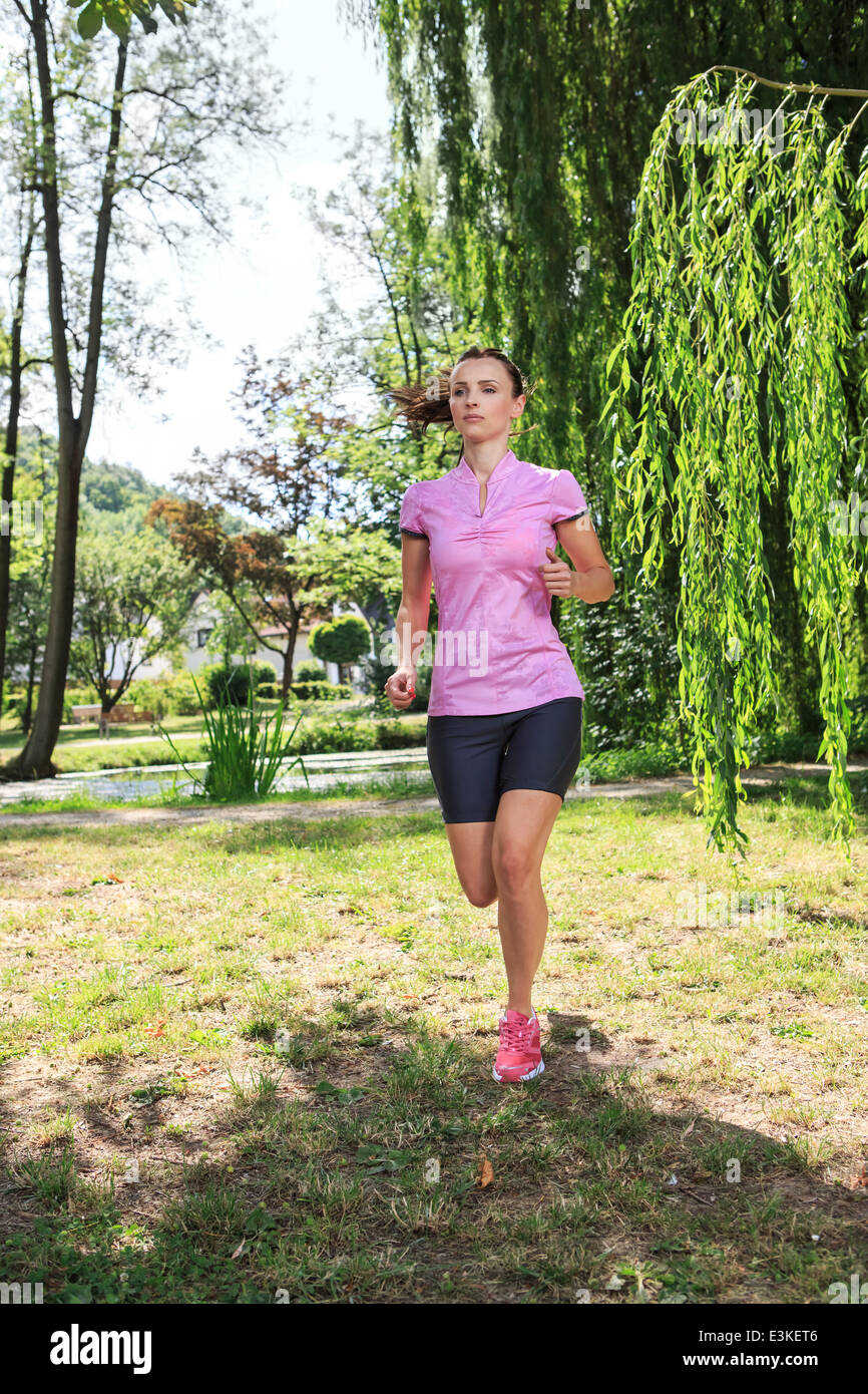 young woman jogging in a park or forest Stock Photo - Alamy