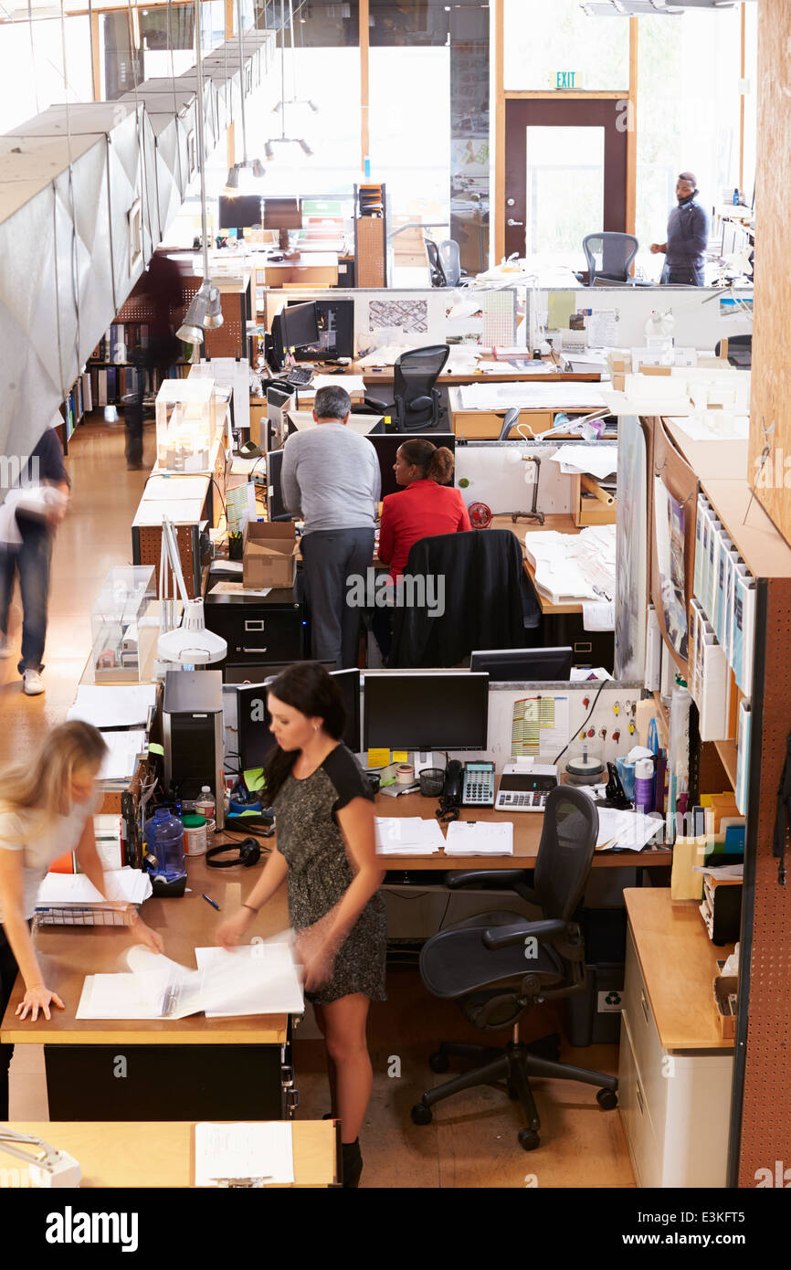 Interior Of Busy Architect's Office With Staff Working Stock Photo