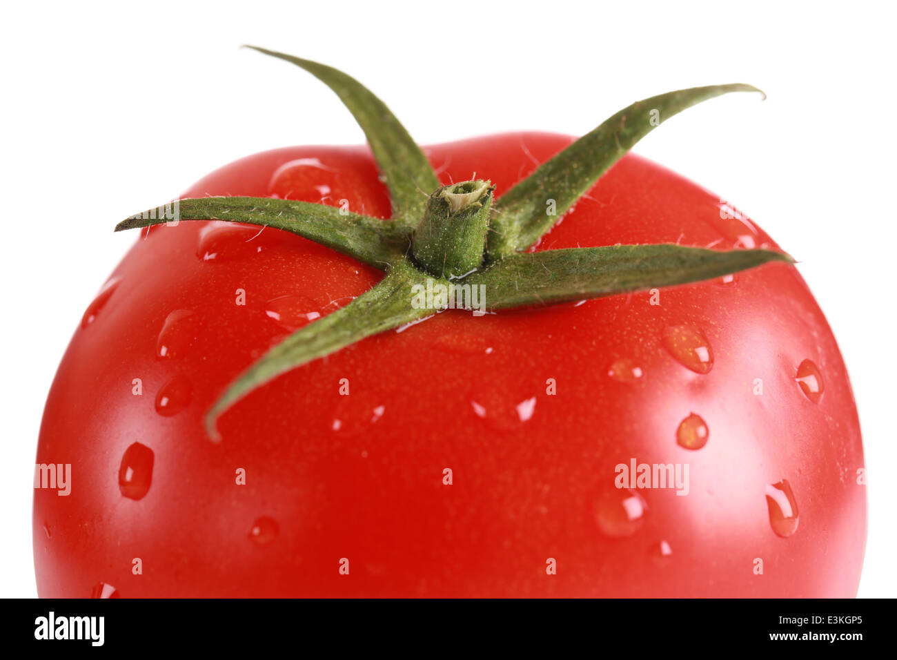 Closeup of a fresh tomato with water drops isolated on white Stock ...