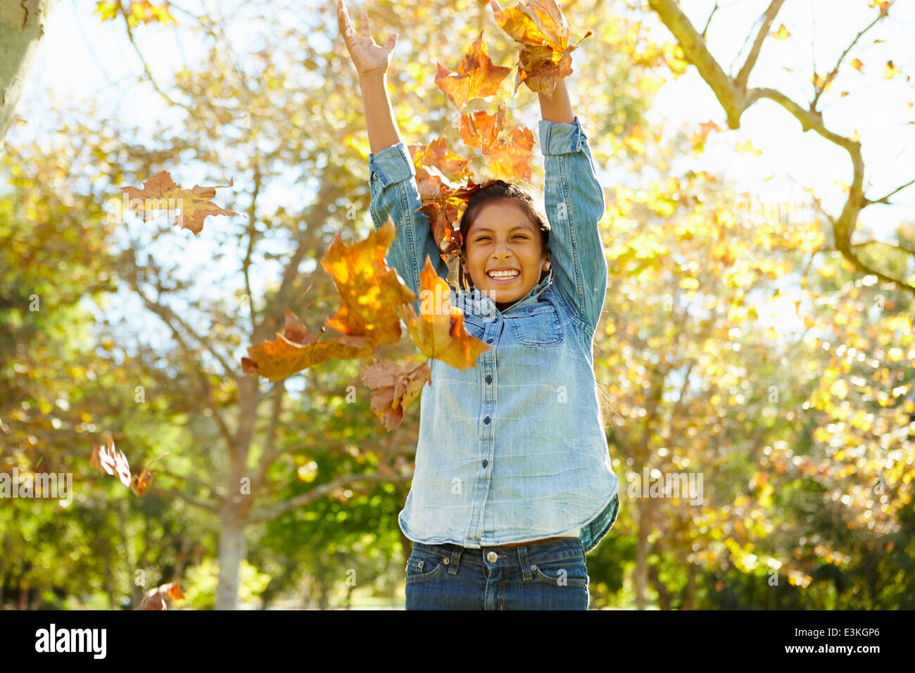Young Girl Throwing Autumn Leaves In The Air Stock Photo Alamy