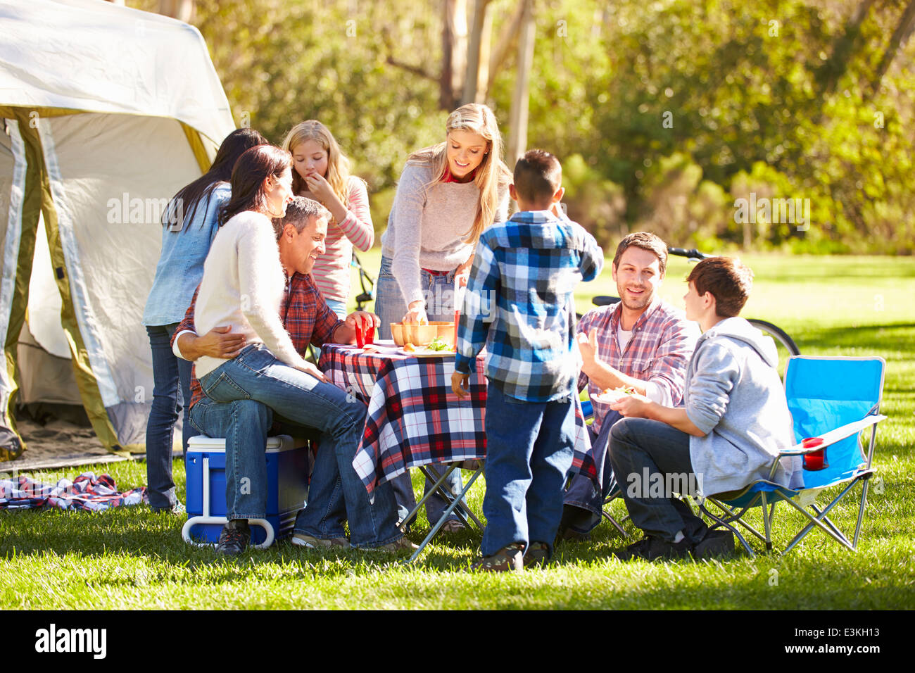 Two Families Enjoying Camping Holiday In Countryside Stock Photo
