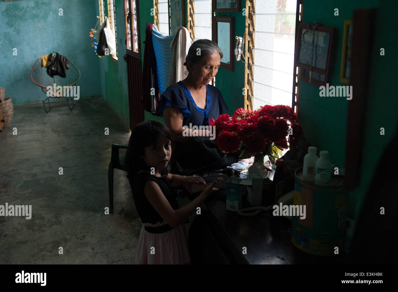 Sept. 29, 2013 - Salvador Urbina, Chiapas, Mexico - LUCIA MENDEZ SICARA stands in her house in Salvador Urbina, Chiapas, Mex. with her granddaughter MAYUMI TERESA MEZA MENDEZ.Coffee cooperatives in Chiapas, Mex. provide economic opportunity in a financially depressed area, giving would-be undocumented immigrants a reason to stay in Mexico. (Credit Image: © Will Seberger/ZUMAPRESS.com) Stock Photo