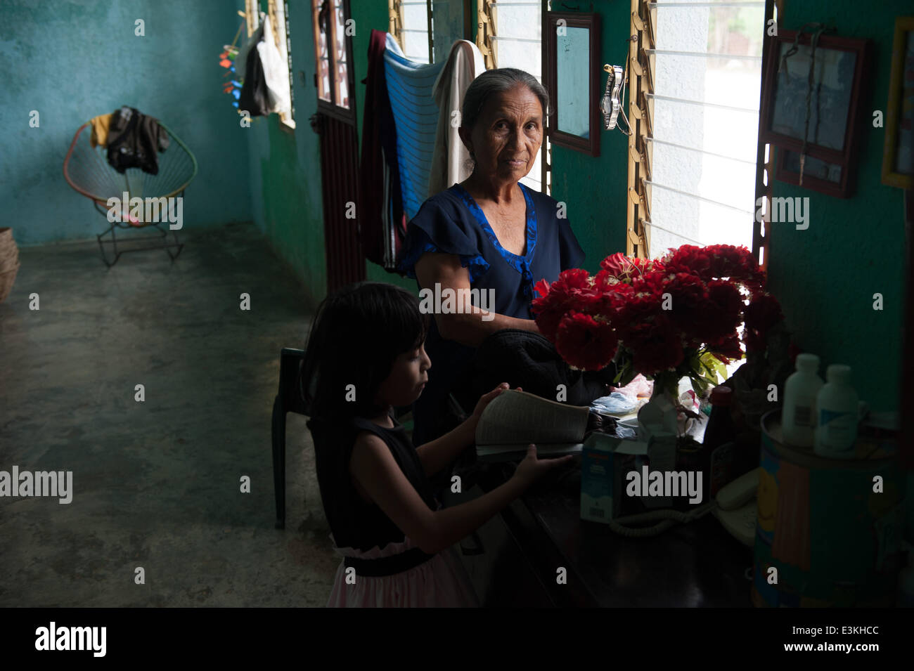 Sept. 29, 2013 - Salvador Urbina, Chiapas, Mexico - LUCIA MENDEZ SICARA stands in her house in Salvador Urbina, Chiapas, Mex. with her granddaughter MAYUMI TERESA MEZA MENDEZ.Coffee cooperatives in Chiapas, Mex. provide economic opportunity in a financially depressed area, giving would-be undocumented immigrants a reason to stay in Mexico. (Credit Image: © Will Seberger/ZUMAPRESS.com) Stock Photo