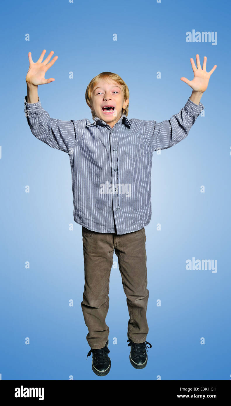 Happy young boy on blue background Stock Photo - Alamy