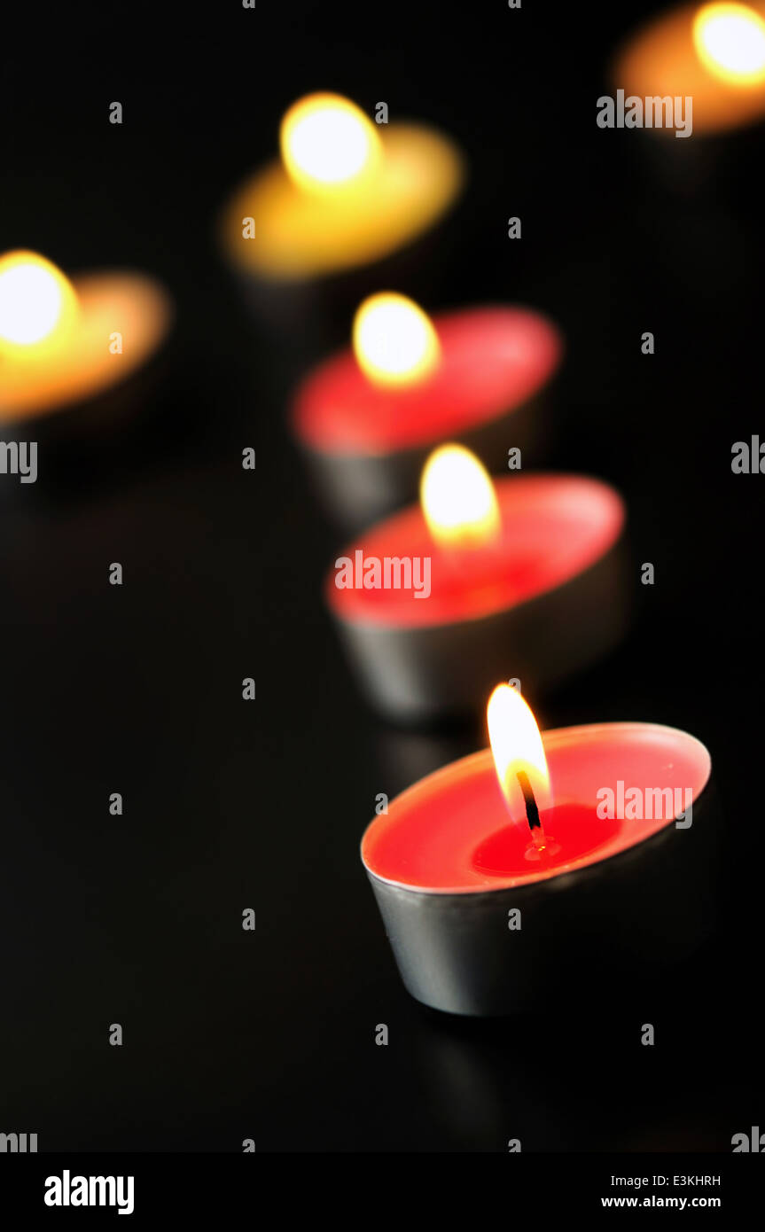 Group of candles burning on black Stock Photo