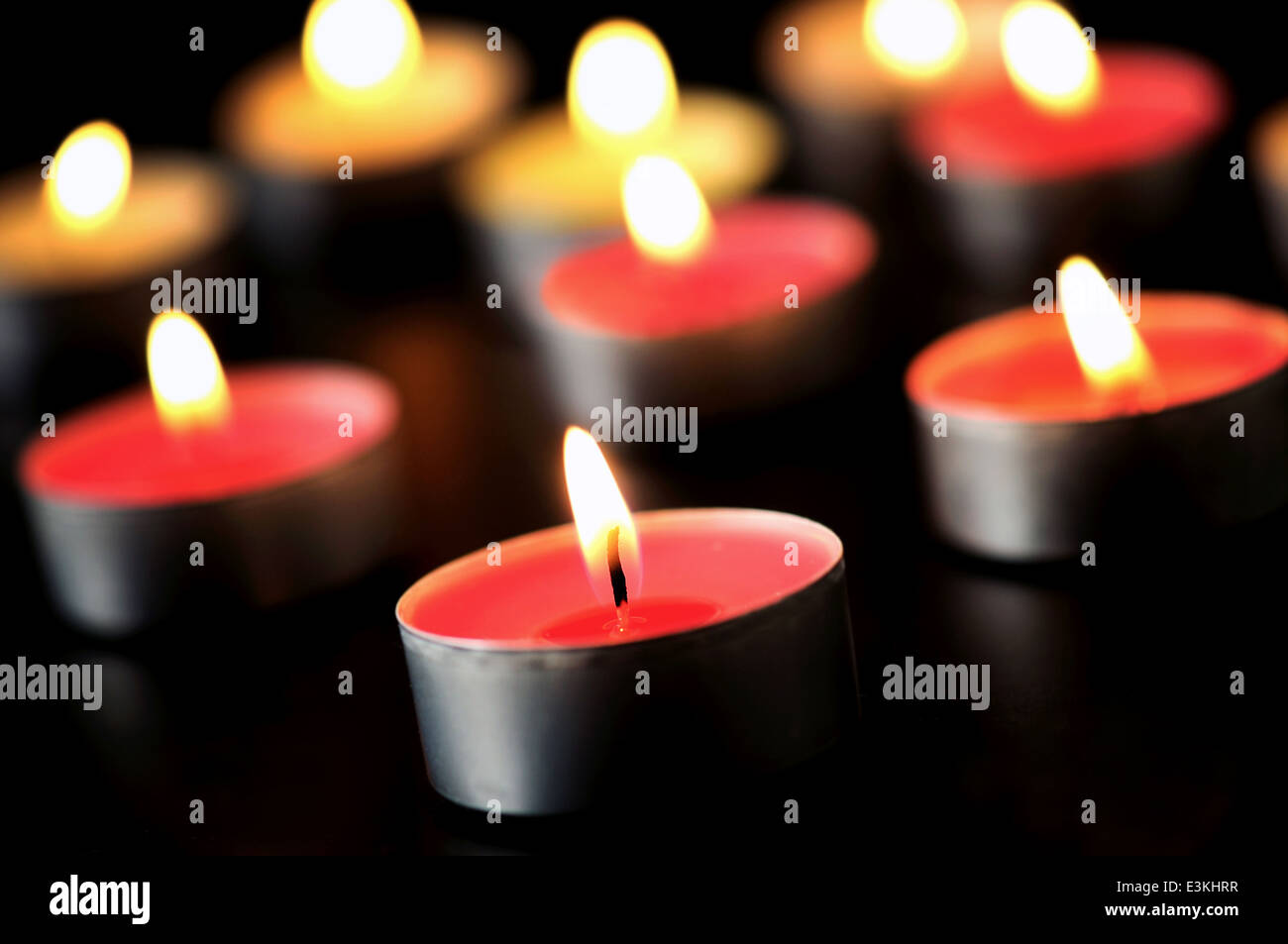 Group of candles burning on black Stock Photo