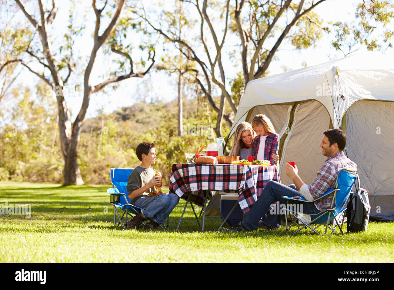 Family Enjoying Camping Holiday In Countryside Stock Photo